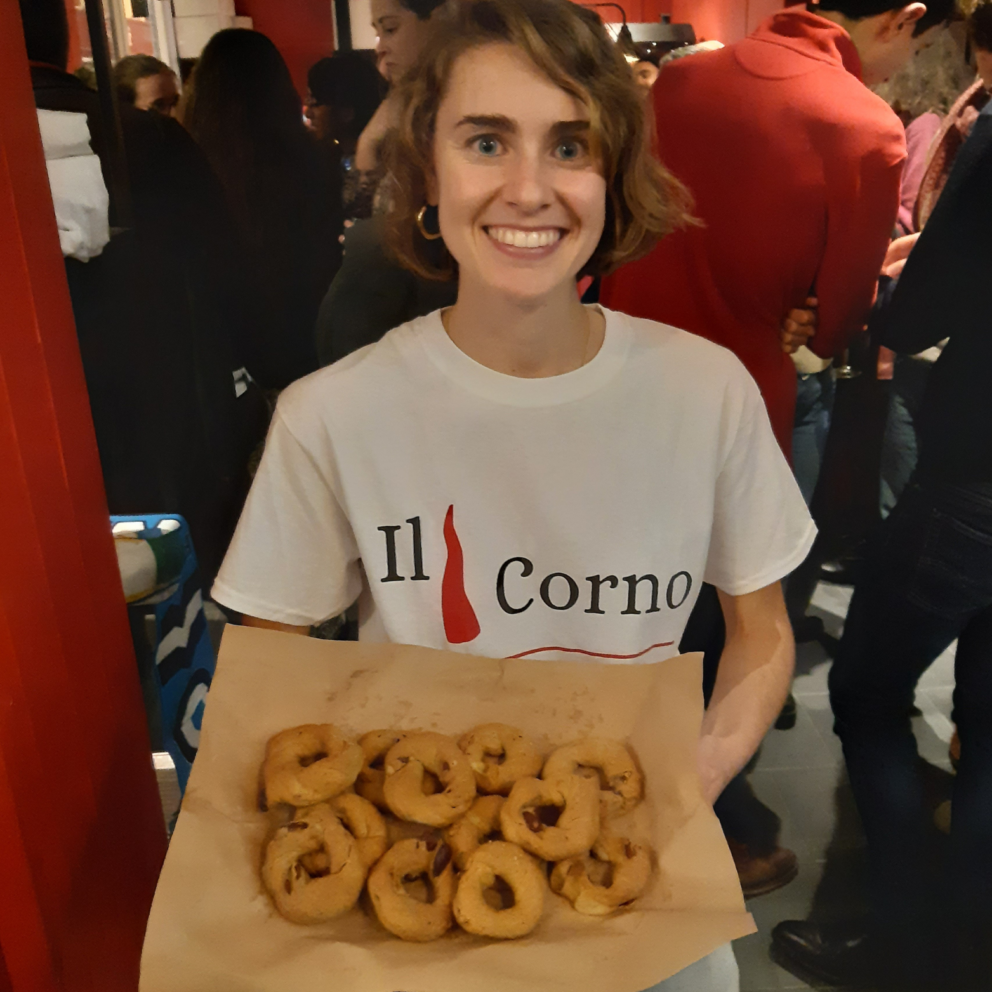 il Corno Manager smiling and holding tray of taralli